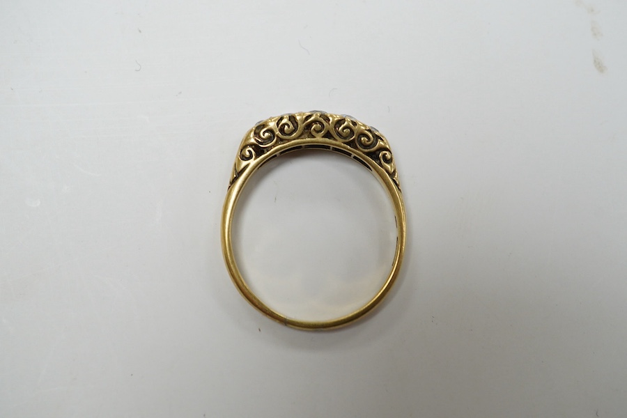 A yellow metal and graduated five stone diamond set half hoop ring, size O, gross weight 3.1 grams. Condition - fair to good